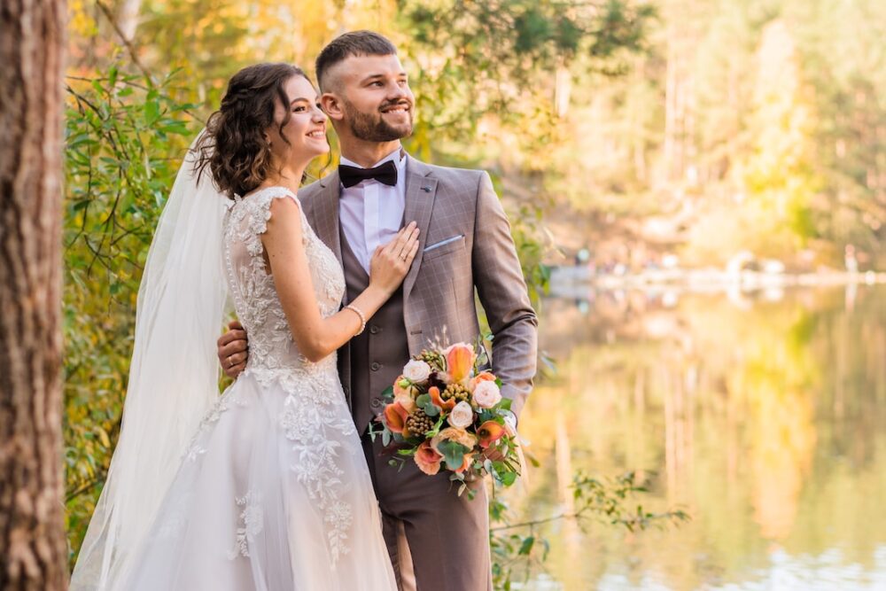 A happy couple posing for photos at a wedding event