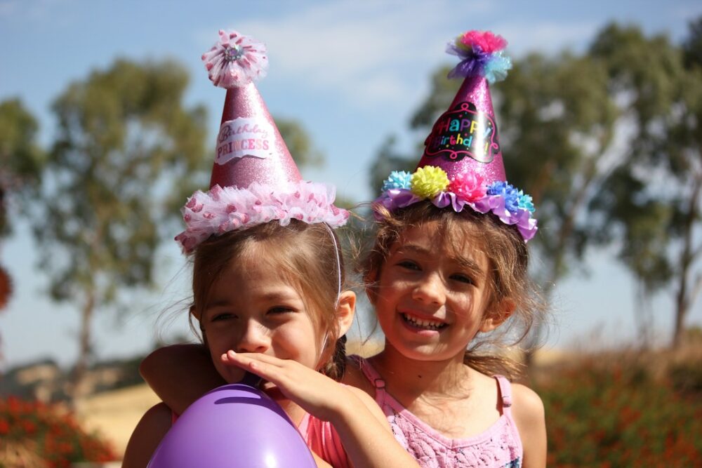 Children wearing party hats at a birthday party