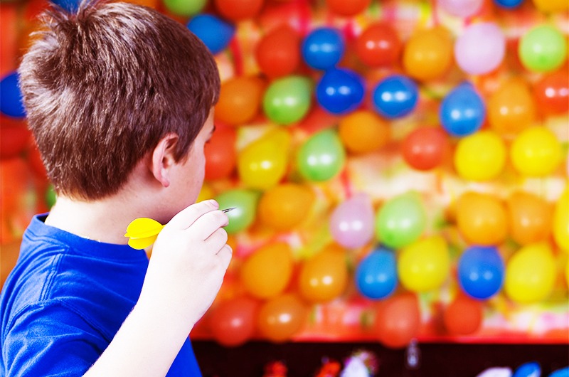 Boy Play Ballon Dart Game
