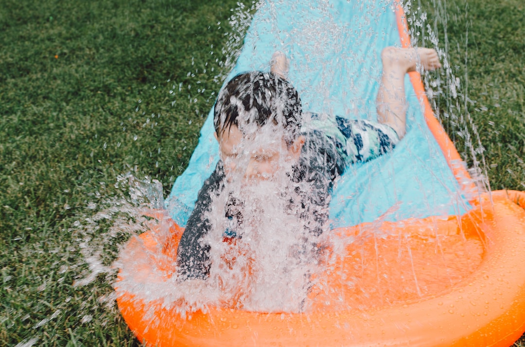hampton-bays-1 A child having fun on a slip-and-slide style water slide