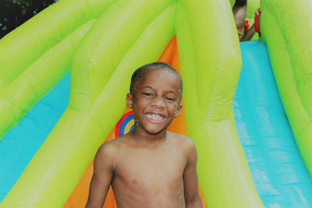 kings-point-2 A child enjoying their time on an inflatable water slide.